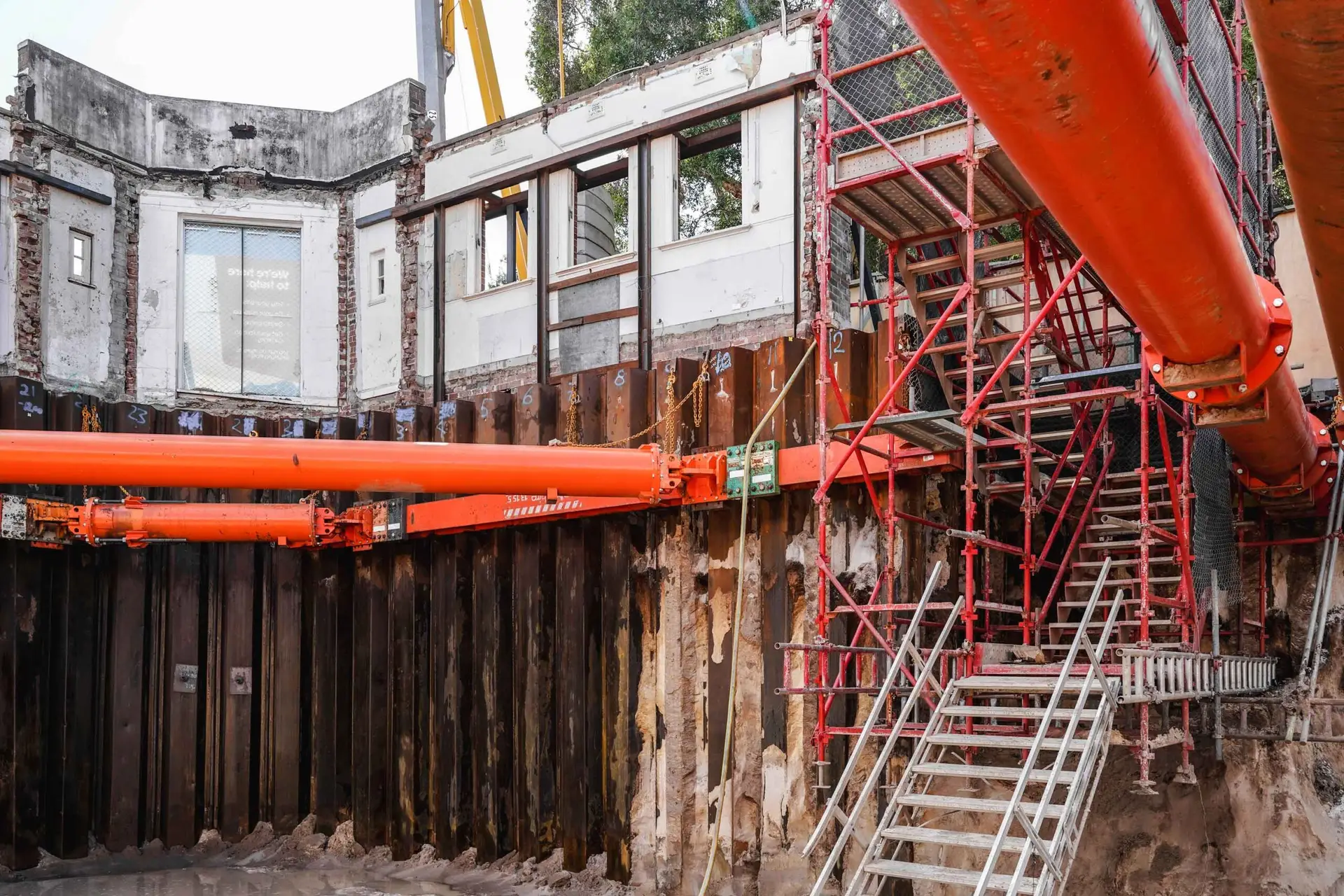 Shoring walls prepared and cleaned, ready for waterproofing membrane installation in a basement.